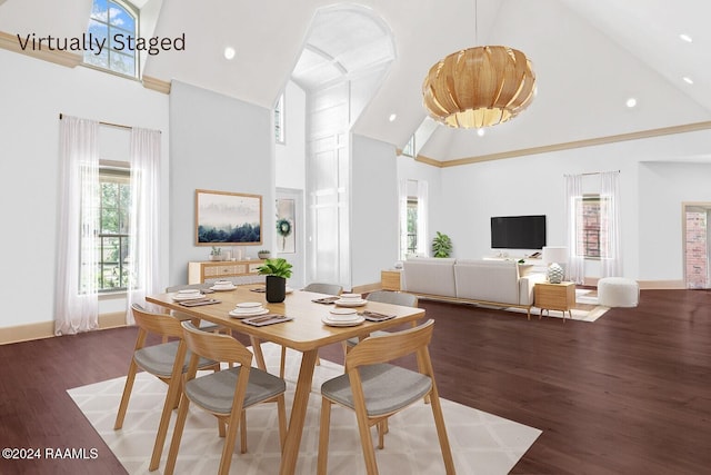 dining room with high vaulted ceiling and dark wood-type flooring