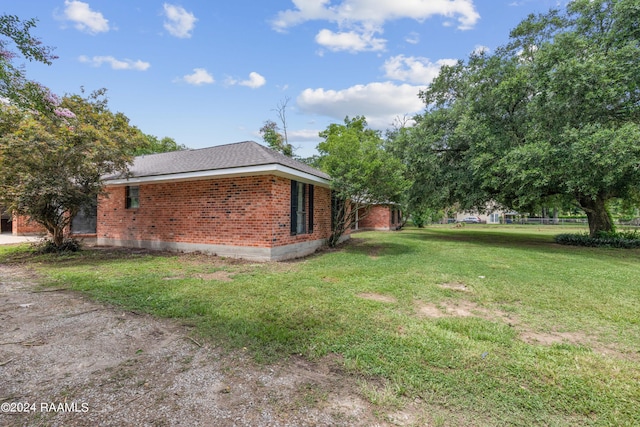 view of property exterior featuring a lawn