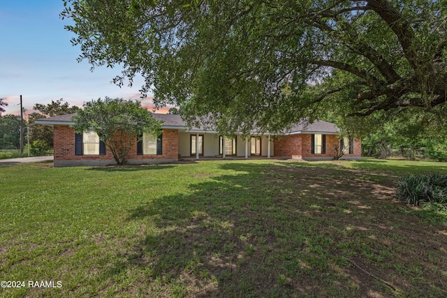 ranch-style house with a lawn