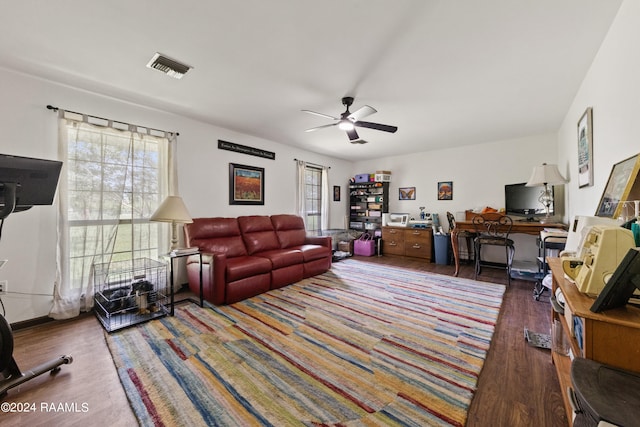 living room with hardwood / wood-style floors and ceiling fan