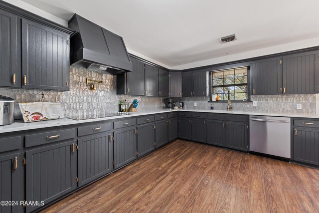 kitchen with premium range hood, black electric stovetop, sink, stainless steel dishwasher, and dark hardwood / wood-style floors