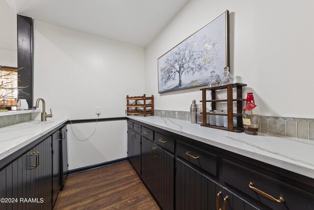 kitchen with light stone countertops and dark hardwood / wood-style floors