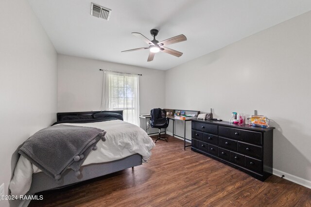 bedroom with ceiling fan and dark hardwood / wood-style floors