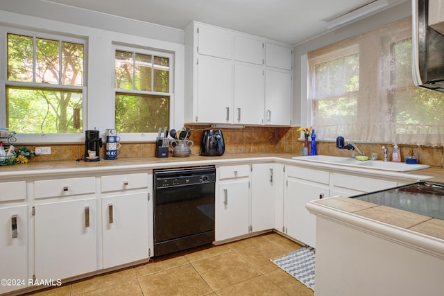 kitchen featuring dishwasher, white cabinets, light tile flooring, and backsplash