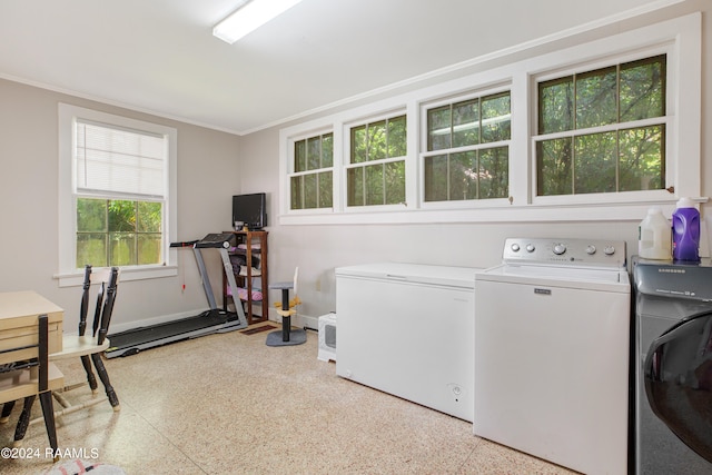 laundry area with ornamental molding and washer and dryer