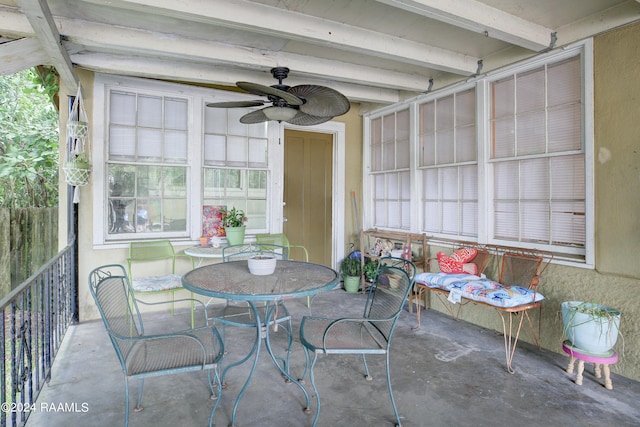 sunroom / solarium featuring ceiling fan