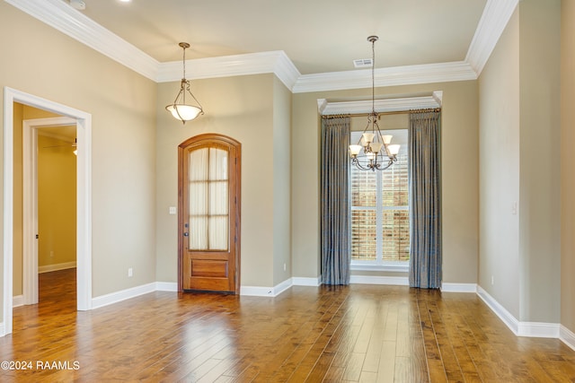 interior space featuring an inviting chandelier, hardwood / wood-style flooring, and ornamental molding