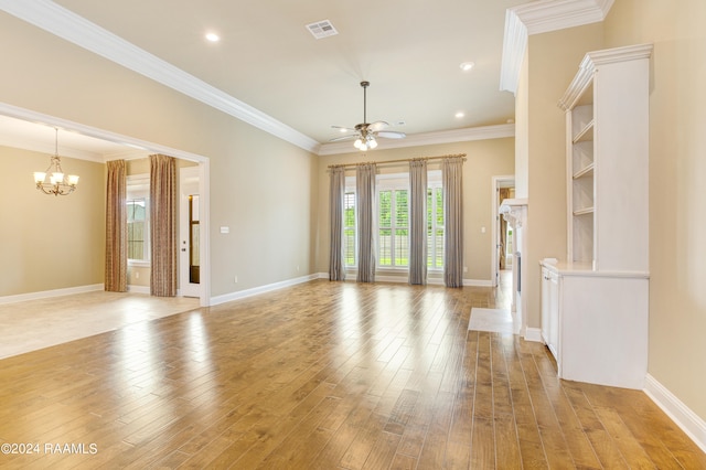 unfurnished living room with ceiling fan with notable chandelier, crown molding, and light hardwood / wood-style flooring