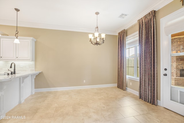 unfurnished dining area with a notable chandelier, sink, ornamental molding, and light tile patterned flooring