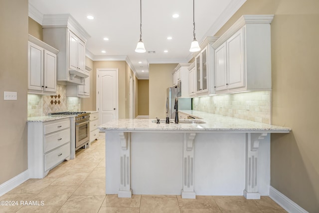 kitchen with high end stove, decorative light fixtures, a breakfast bar, and white cabinetry