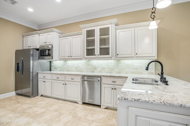 kitchen with white cabinets, appliances with stainless steel finishes, crown molding, and sink