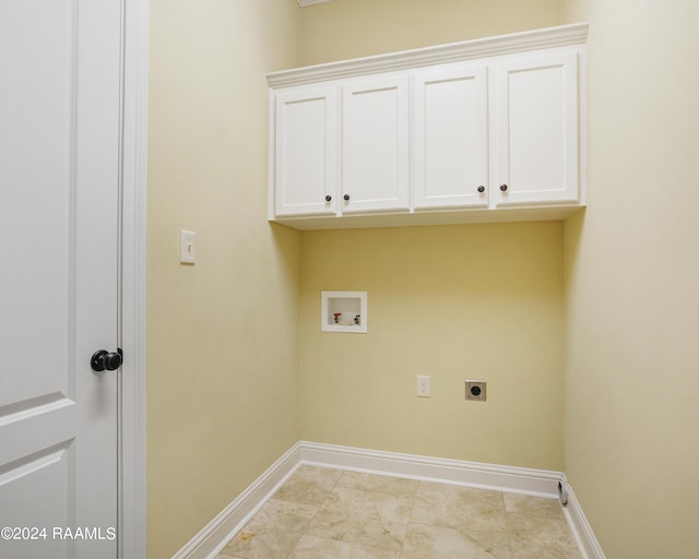 washroom with hookup for a washing machine, hookup for an electric dryer, and cabinets