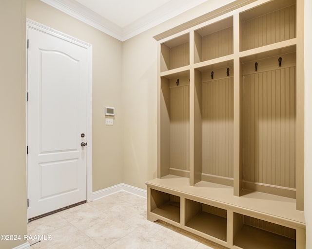 mudroom with crown molding and tile patterned floors