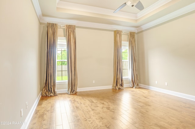 spare room featuring ornamental molding, light wood-type flooring, and ceiling fan