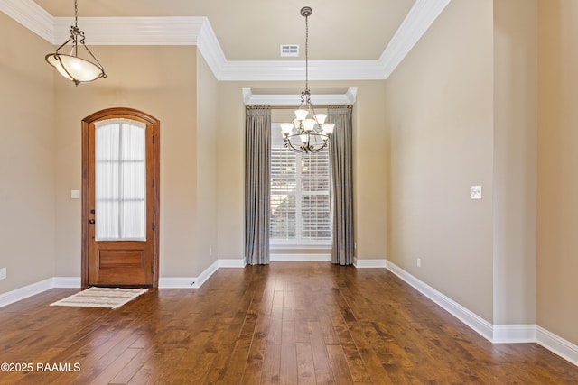 entrance foyer with baseboards, a chandelier, dark wood-style flooring, and ornamental molding