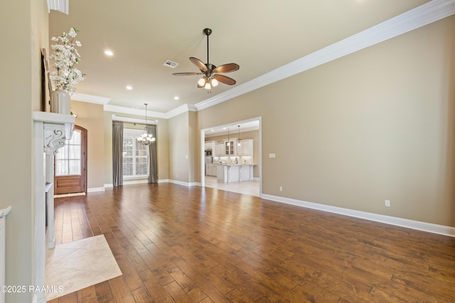 unfurnished living room featuring ornamental molding, ceiling fan with notable chandelier, baseboards, and hardwood / wood-style flooring