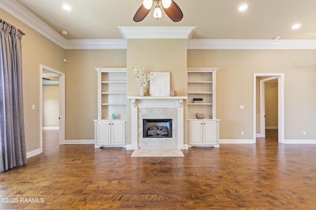 unfurnished living room featuring ceiling fan, crown molding, wood finished floors, and a high end fireplace