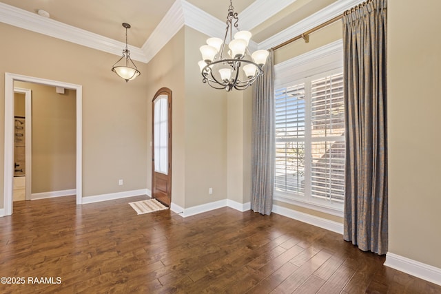 interior space featuring dark wood-type flooring, arched walkways, ornamental molding, and baseboards