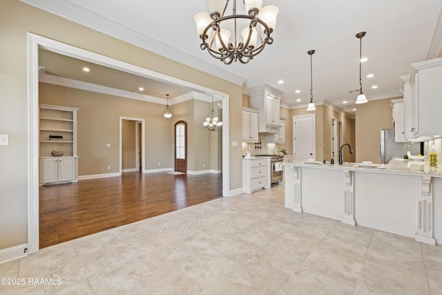 kitchen with open floor plan, a kitchen breakfast bar, a peninsula, an inviting chandelier, and stainless steel appliances