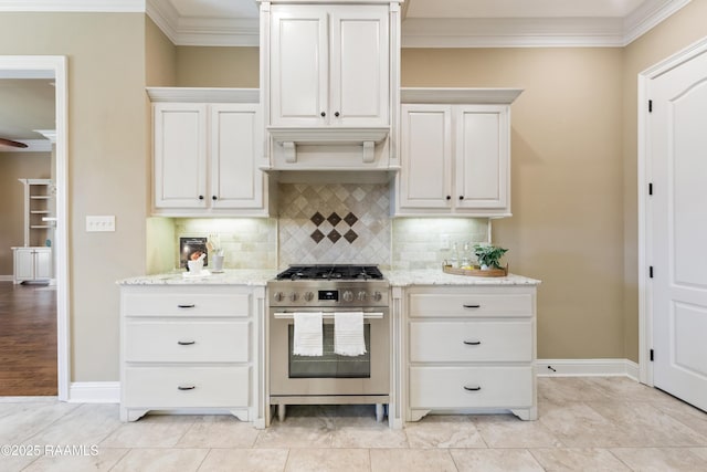 kitchen with crown molding, light stone counters, tasteful backsplash, and stainless steel range with gas stovetop