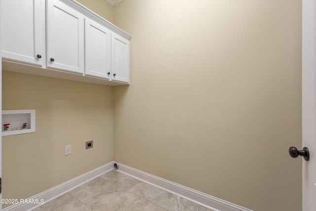 clothes washing area featuring cabinet space, light tile patterned floors, baseboards, hookup for an electric dryer, and washer hookup