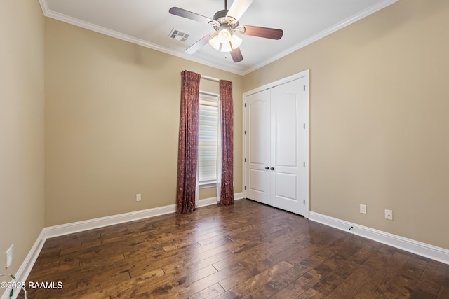 unfurnished room with baseboards, visible vents, hardwood / wood-style floors, and ornamental molding