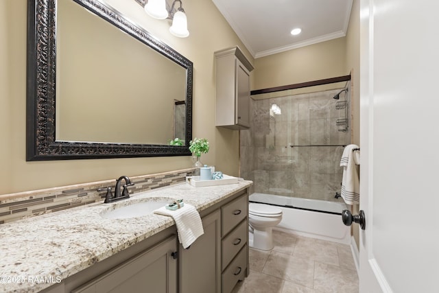 full bath with toilet, ornamental molding, tile patterned floors, vanity, and shower / washtub combination