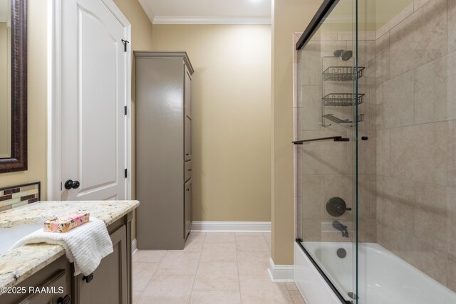 full bath featuring tile patterned flooring, vanity, baseboards, combined bath / shower with glass door, and crown molding