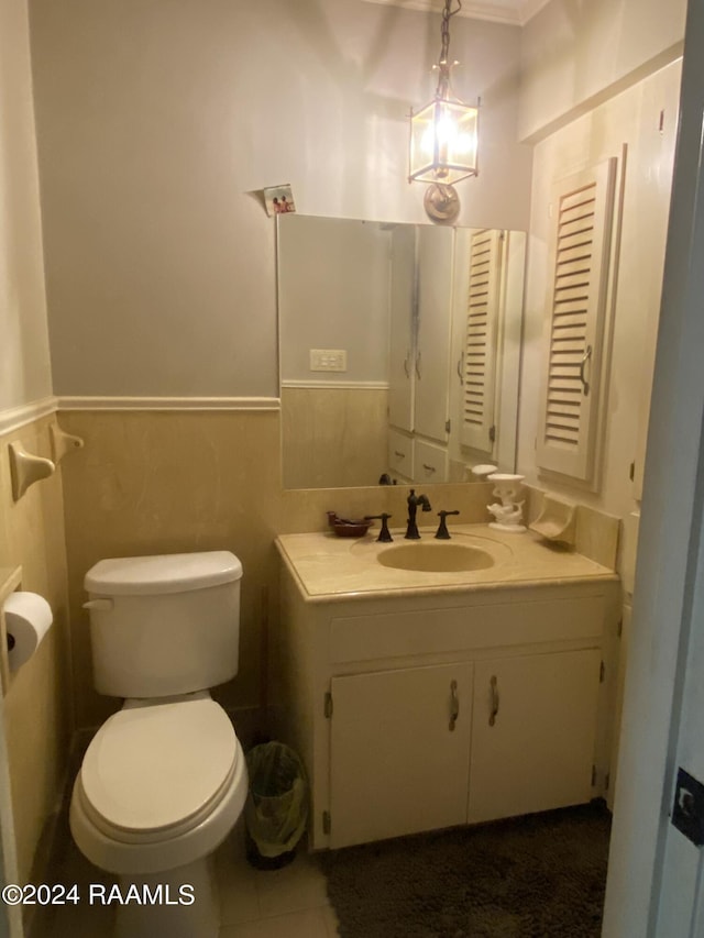 bathroom with tile patterned floors, vanity, tile walls, and toilet