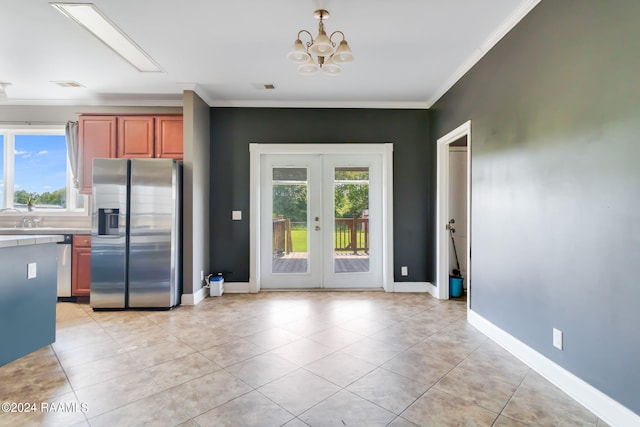 kitchen featuring appliances with stainless steel finishes, french doors, ornamental molding, a notable chandelier, and light tile patterned flooring