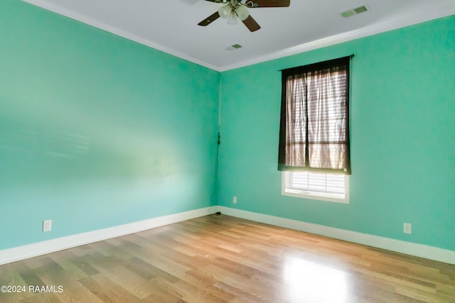 empty room with ceiling fan, light hardwood / wood-style floors, and ornamental molding