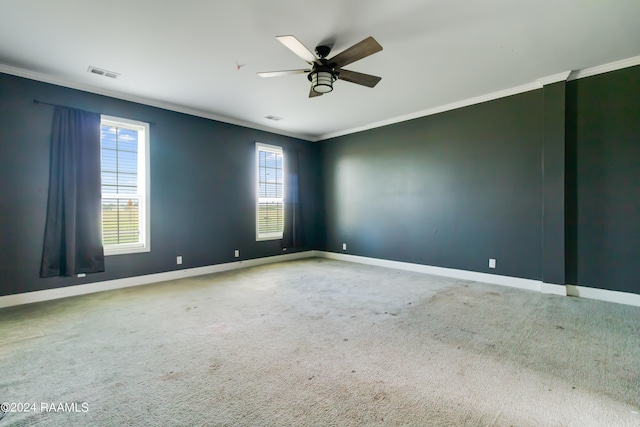 carpeted spare room featuring ceiling fan and ornamental molding