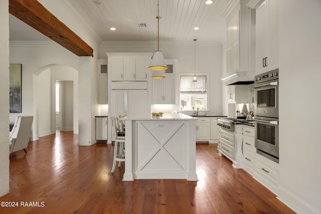 kitchen featuring dark hardwood / wood-style flooring, white cabinets, hanging light fixtures, and a kitchen island