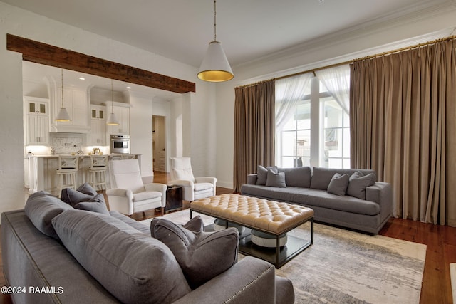 living room featuring wood-type flooring and crown molding