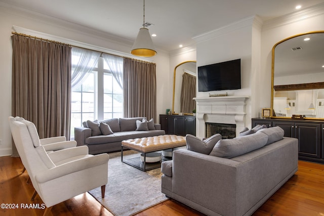 living room with crown molding and light hardwood / wood-style floors