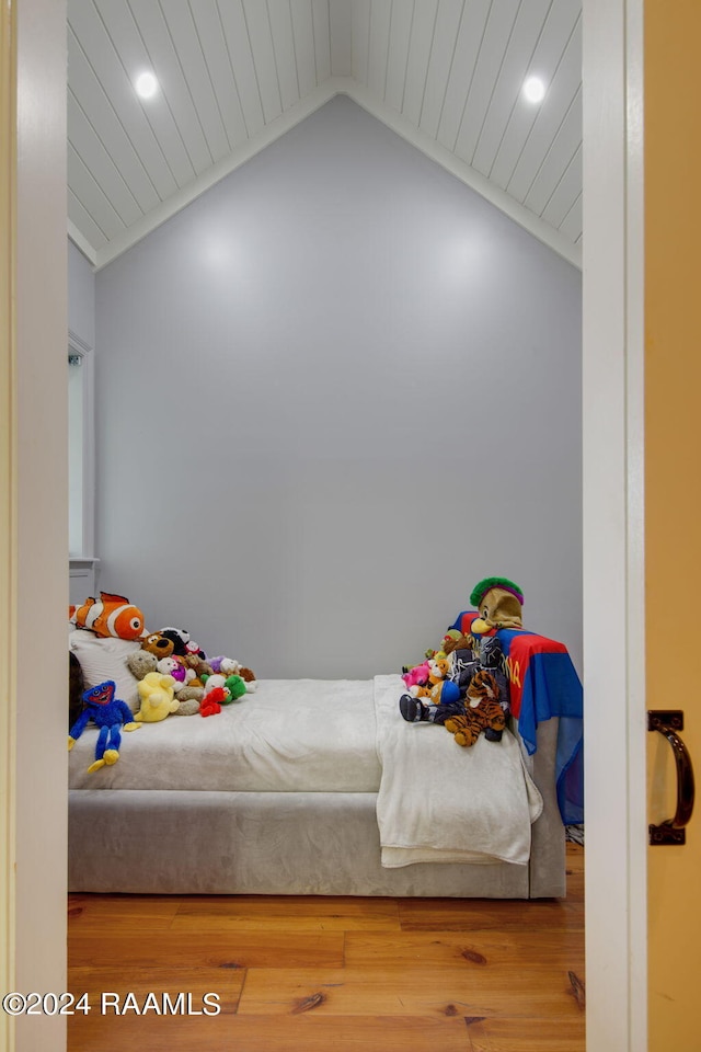 bedroom featuring hardwood / wood-style floors and lofted ceiling