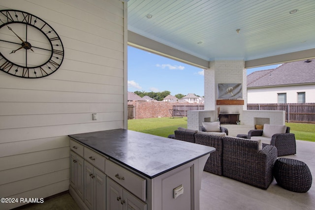 view of patio / terrace with an outdoor living space with a fireplace