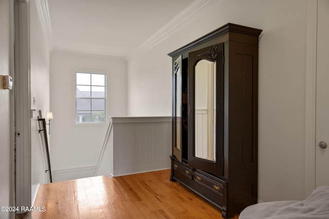 interior space with light hardwood / wood-style floors and crown molding