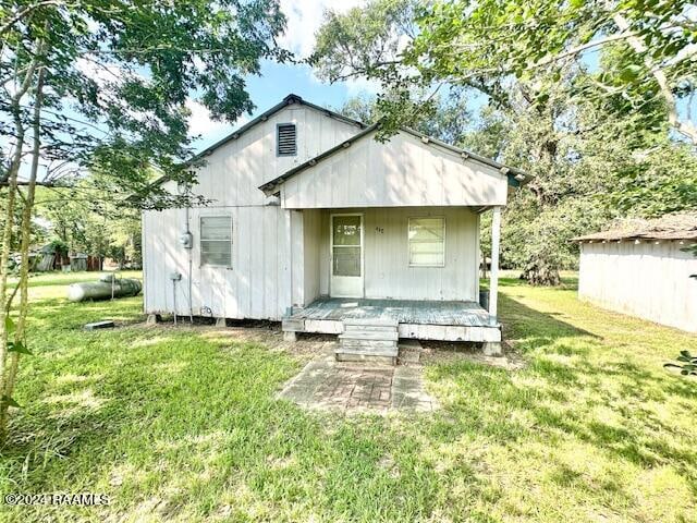 rear view of house with a yard