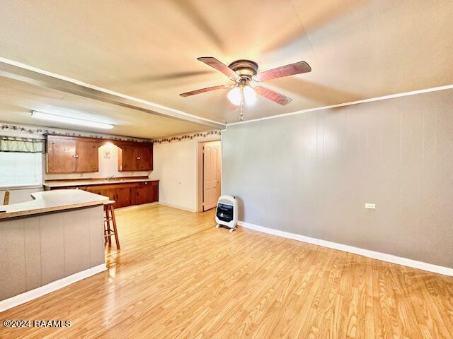 unfurnished living room featuring light hardwood / wood-style flooring and ceiling fan