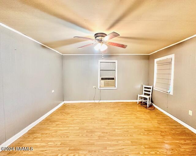 unfurnished room featuring crown molding, cooling unit, hardwood / wood-style floors, and ceiling fan