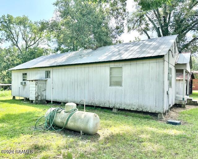 view of side of property with a lawn