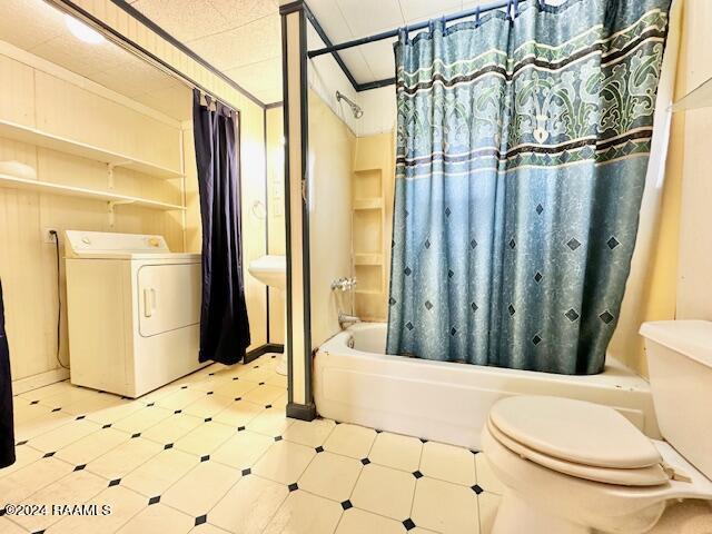 bathroom with washer / clothes dryer, tile patterned floors, toilet, and shower / bathtub combination with curtain