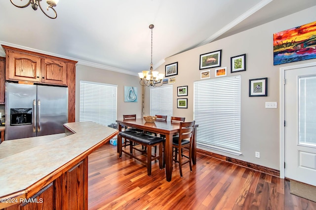 dining room featuring a chandelier, ornamental molding, dark hardwood / wood-style flooring, and lofted ceiling