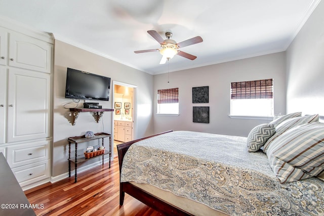 bedroom featuring connected bathroom, hardwood / wood-style flooring, ceiling fan, and ornamental molding