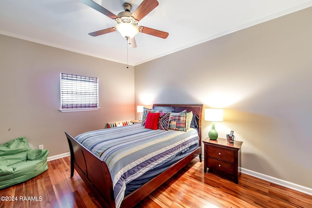 bedroom featuring ceiling fan, hardwood / wood-style flooring, and ornamental molding