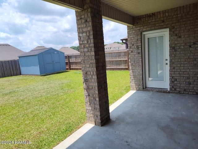 view of yard with a shed and a patio