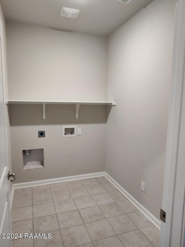 laundry area featuring hookup for an electric dryer, washer hookup, and light tile patterned floors