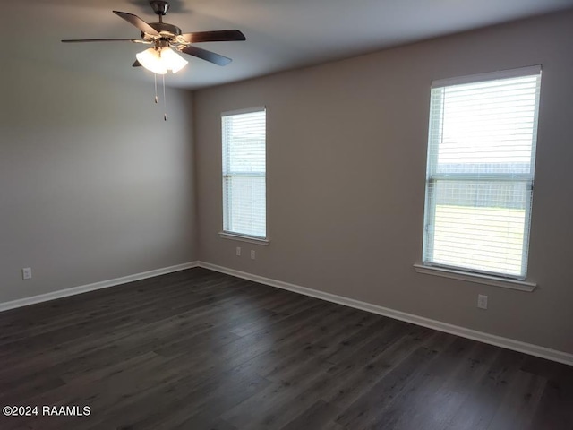 unfurnished room with plenty of natural light, ceiling fan, and dark wood-type flooring