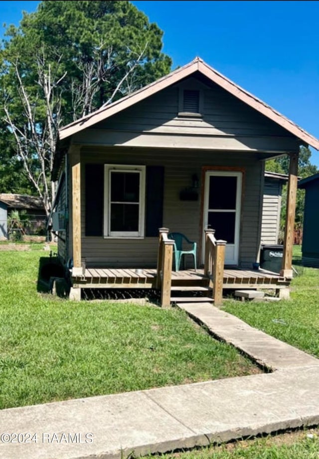 bungalow-style house with a front yard and a porch